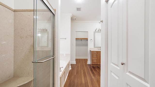 bathroom featuring an enclosed shower, hardwood / wood-style floors, vanity, and crown molding