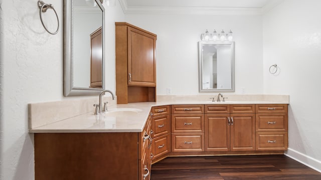 bathroom with crown molding, hardwood / wood-style floors, and vanity