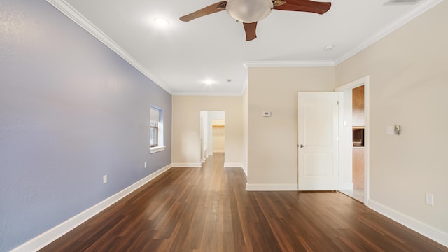 empty room featuring dark hardwood / wood-style flooring, ornamental molding, and ceiling fan