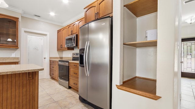 kitchen featuring ornamental molding, appliances with stainless steel finishes, and light tile patterned floors