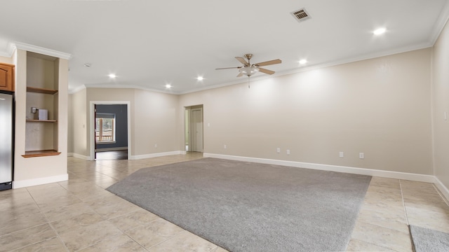 spare room featuring crown molding, ceiling fan, and light tile patterned flooring