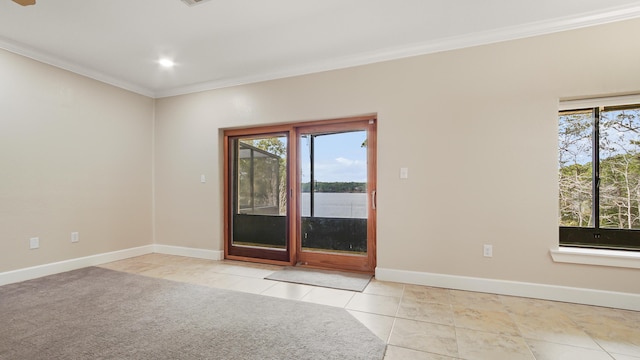 spare room featuring a water view, ornamental molding, and light tile patterned floors