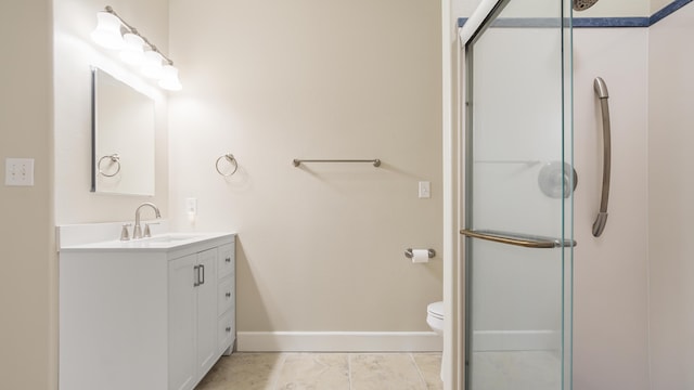 bathroom with vanity, tile patterned flooring, a shower with door, and toilet