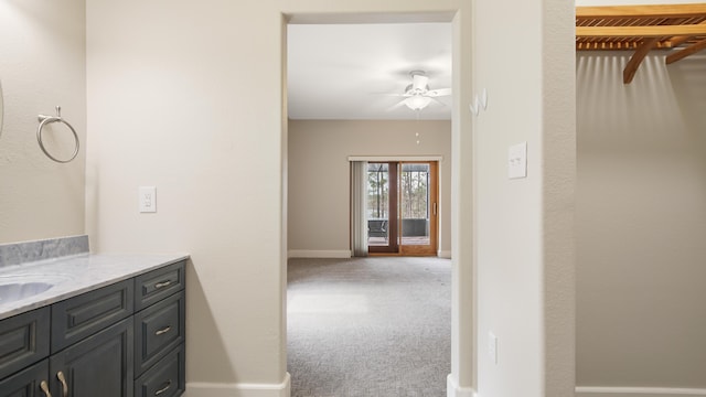 bathroom featuring ceiling fan and vanity