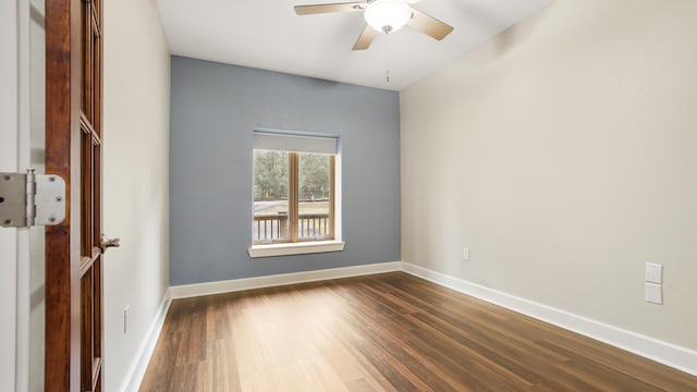 empty room featuring dark wood-type flooring and ceiling fan