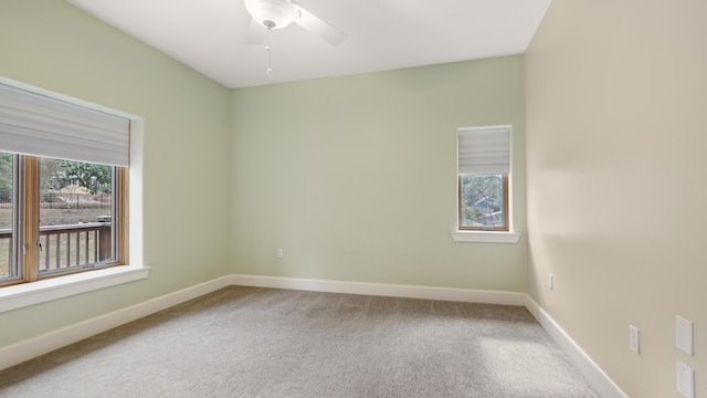 carpeted spare room with ceiling fan