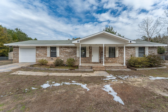 ranch-style house featuring a garage and covered porch