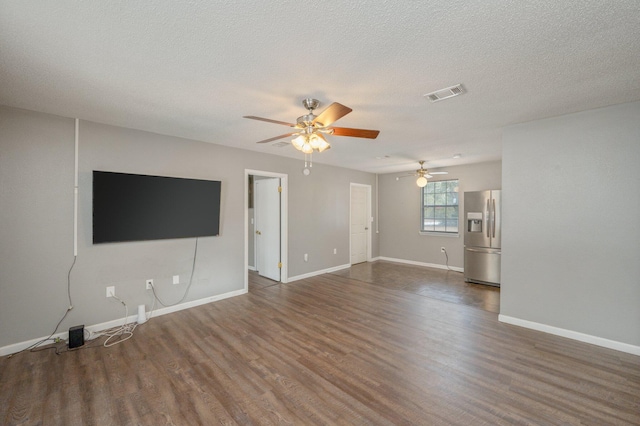 unfurnished living room with ceiling fan, a textured ceiling, and dark hardwood / wood-style flooring