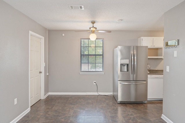 kitchen featuring stainless steel fridge, ceiling fan, white cabinetry, white dishwasher, and a textured ceiling