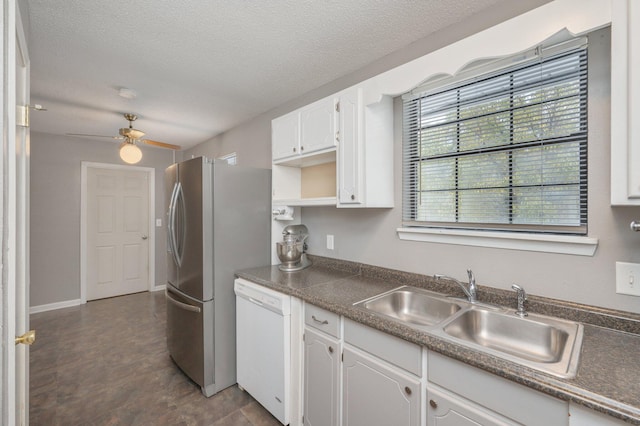 kitchen with sink, ceiling fan, white cabinetry, white dishwasher, and a textured ceiling