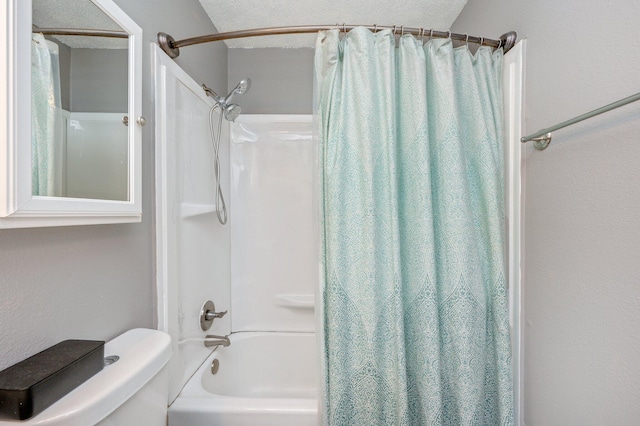 bathroom with shower / bath combo, a textured ceiling, and toilet