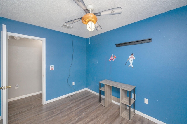 interior space with dark hardwood / wood-style flooring, a textured ceiling, and ceiling fan