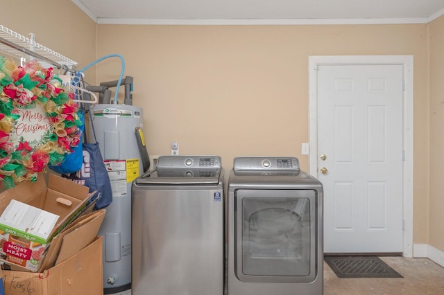 laundry room featuring crown molding, water heater, and washer and dryer