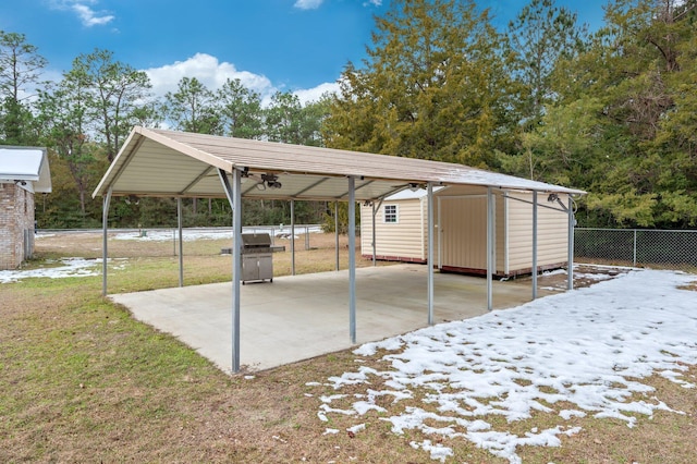 view of parking / parking lot featuring a yard and a carport