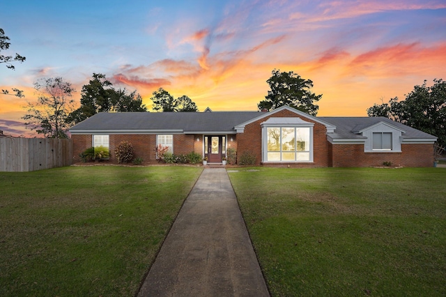 single story home featuring a yard