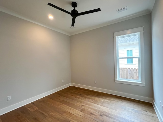 empty room with ceiling fan, light wood-type flooring, and crown molding