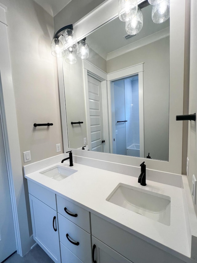 bathroom with ornamental molding and vanity