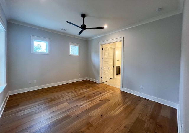 unfurnished bedroom with ceiling fan, crown molding, and wood-type flooring