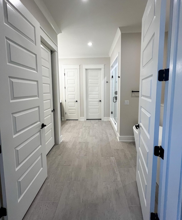 hallway featuring ornamental molding