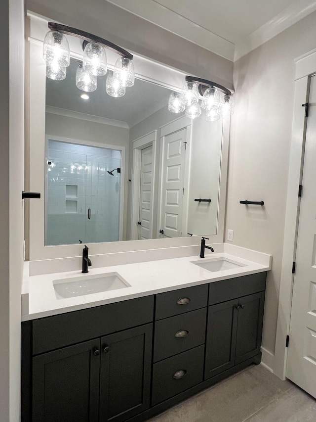 bathroom with vanity, crown molding, and a shower with door