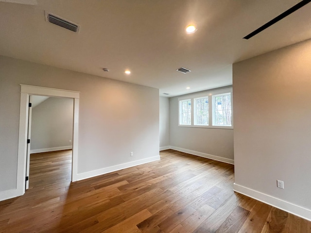 spare room with hardwood / wood-style floors