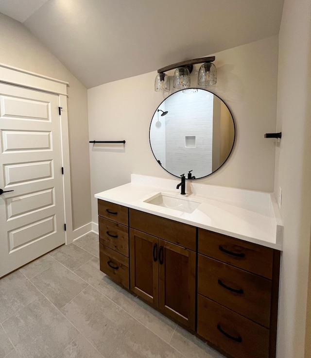 bathroom with vanity and lofted ceiling