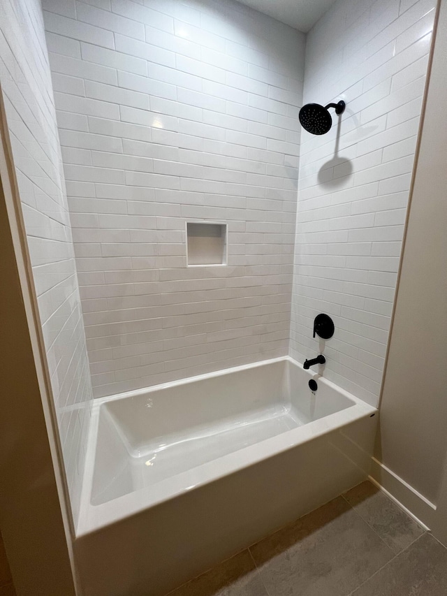 bathroom with tiled shower / bath and tile patterned flooring