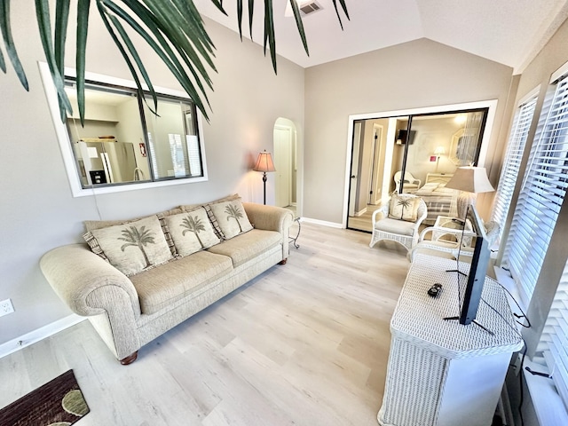 living room with lofted ceiling and hardwood / wood-style flooring