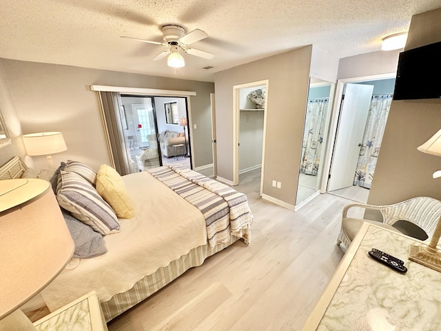 bedroom with ceiling fan, a textured ceiling, and light wood-type flooring