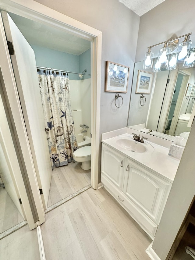 full bathroom with toilet, shower / tub combo, vanity, and hardwood / wood-style flooring