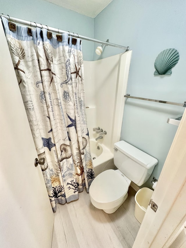 bathroom featuring toilet, shower / tub combo, and wood-type flooring