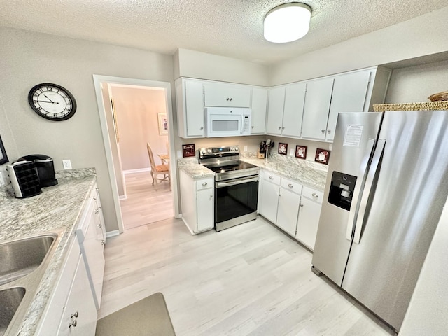 kitchen featuring light hardwood / wood-style floors, sink, white cabinetry, and stainless steel appliances