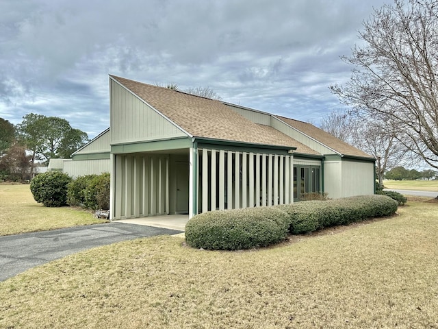 view of property exterior featuring a lawn and a carport