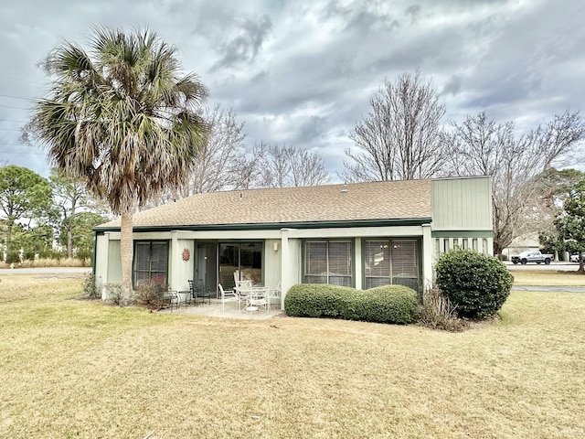 back of property featuring a lawn and a patio