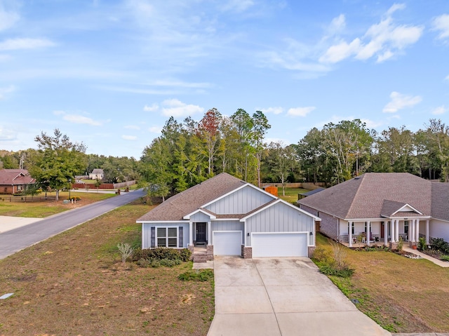 8177 Majestic Cypress Dr, Milton, FL 32583 - view of front of home featuring a front lawn, an attached garage, board and batten siding, and concrete driveway