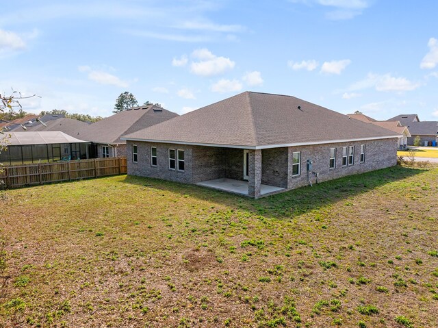 8177 Majestic Cypress Dr, Milton, FL 32583 - rear view of house with brick siding, fence, a yard, and a patio area
