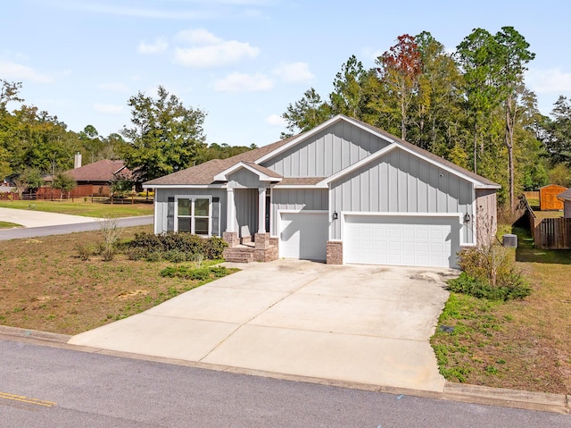 8177 Majestic Cypress Dr, Milton, FL 32583 - view of front facade with board and batten siding, driveway, and an attached garage