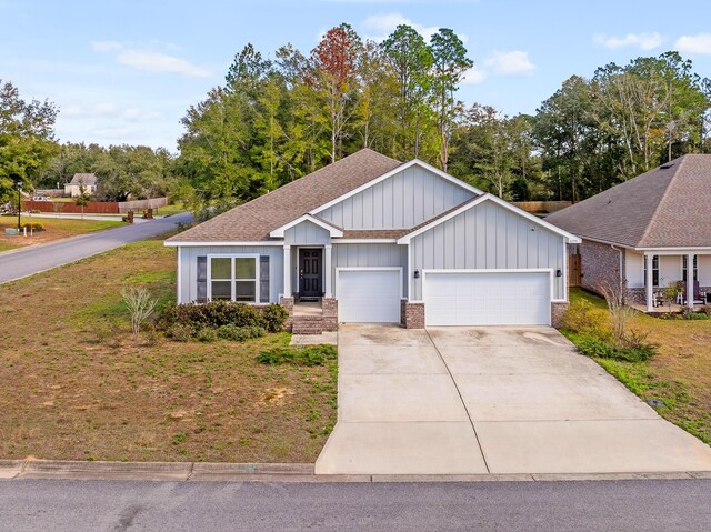 8177 Majestic Cypress Dr, Milton, FL 32583 - ranch-style home with an attached garage, a front lawn, concrete driveway, and board and batten siding