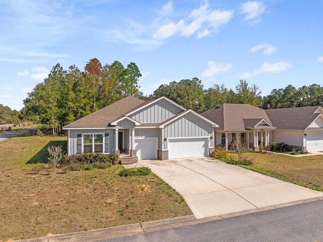 8177 Majestic Cypress Dr, Milton, FL 32583 - view of front facade with board and batten siding, a front yard, driveway, and an attached garage