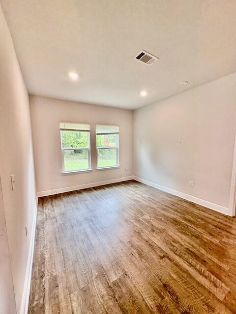 8177 Majestic Cypress Dr, Milton, FL 32583 - unfurnished room featuring recessed lighting, visible vents, baseboards, and wood finished floors