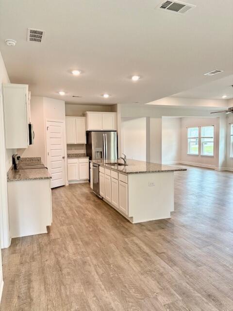 8177 Majestic Cypress Dr, Milton, FL 32583 - kitchen with light wood-style flooring, visible vents, and open floor plan