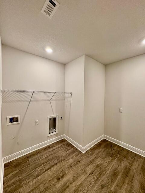 8177 Majestic Cypress Dr, Milton, FL 32583 - washroom featuring washer hookup, wood finished floors, electric dryer hookup, laundry area, and visible vents
