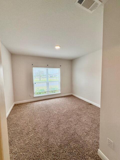 8177 Majestic Cypress Dr, Milton, FL 32583 - carpeted spare room featuring baseboards and visible vents