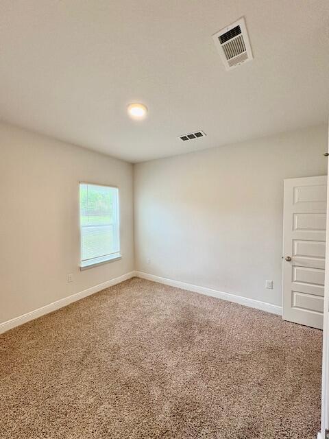 8177 Majestic Cypress Dr, Milton, FL 32583 - spare room featuring baseboards, visible vents, and carpet flooring