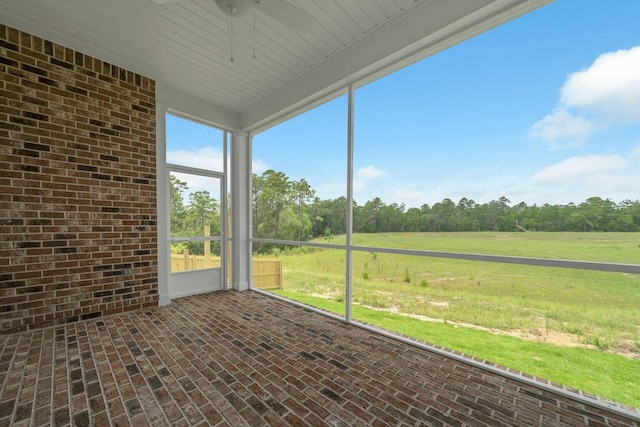 unfurnished sunroom featuring a rural view