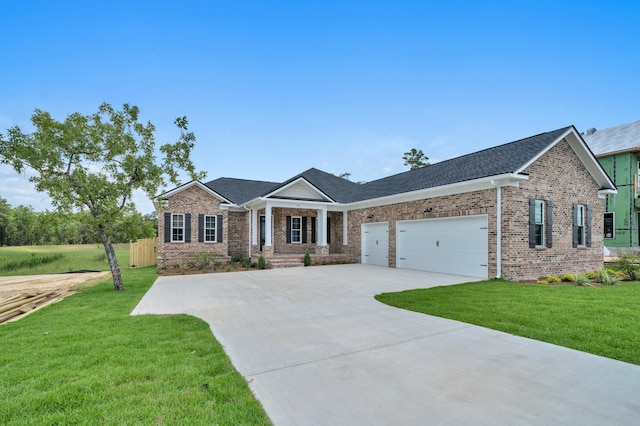 view of front of property featuring a garage and a front lawn