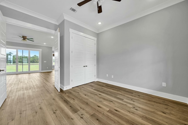 unfurnished bedroom featuring ceiling fan, light hardwood / wood-style floors, crown molding, and access to outside