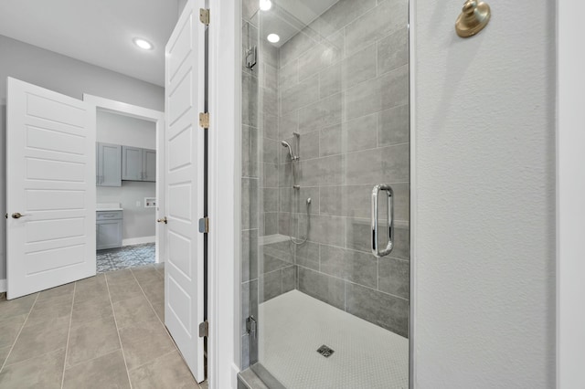 bathroom featuring walk in shower and tile patterned flooring