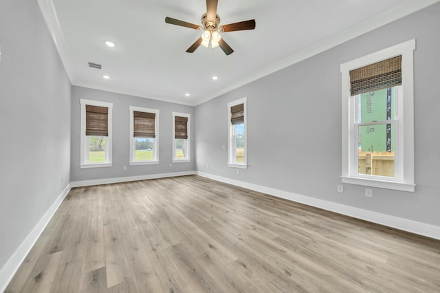 empty room featuring light hardwood / wood-style floors, ornamental molding, and ceiling fan