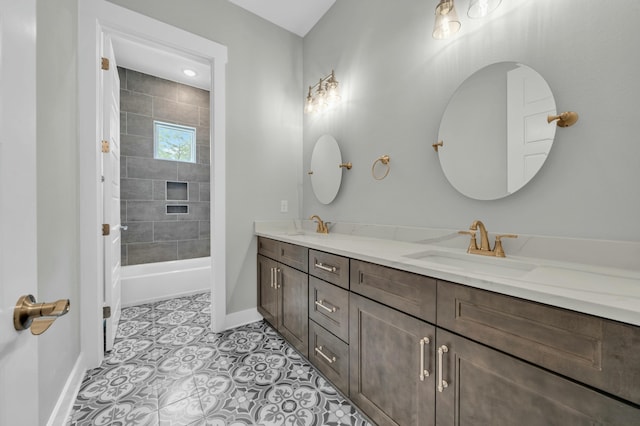 bathroom with tiled shower / bath combo, vanity, and tile patterned flooring